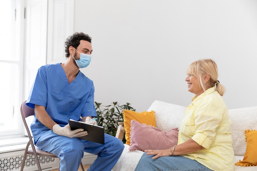 nurse talking to elderly woman