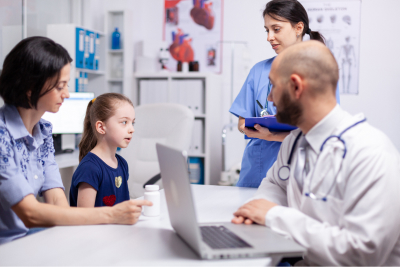 doctor and patients looking at x-ray sitting in medical office