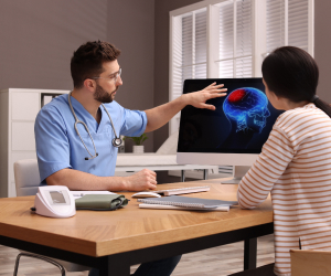 doctor showing brain scan to patient