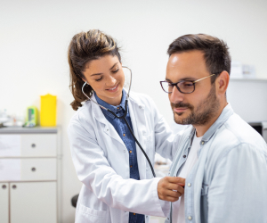 doctor using stethoscope on the patient