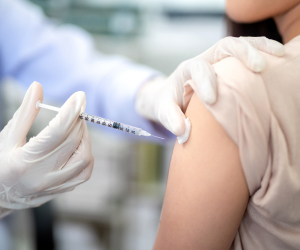 doctor injecting vaccine to patient