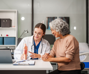 doctor talking to elderly patient