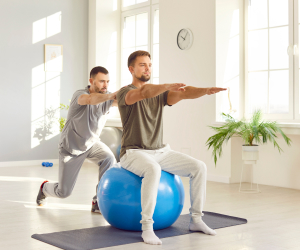 male caregiver helping a man to exercise