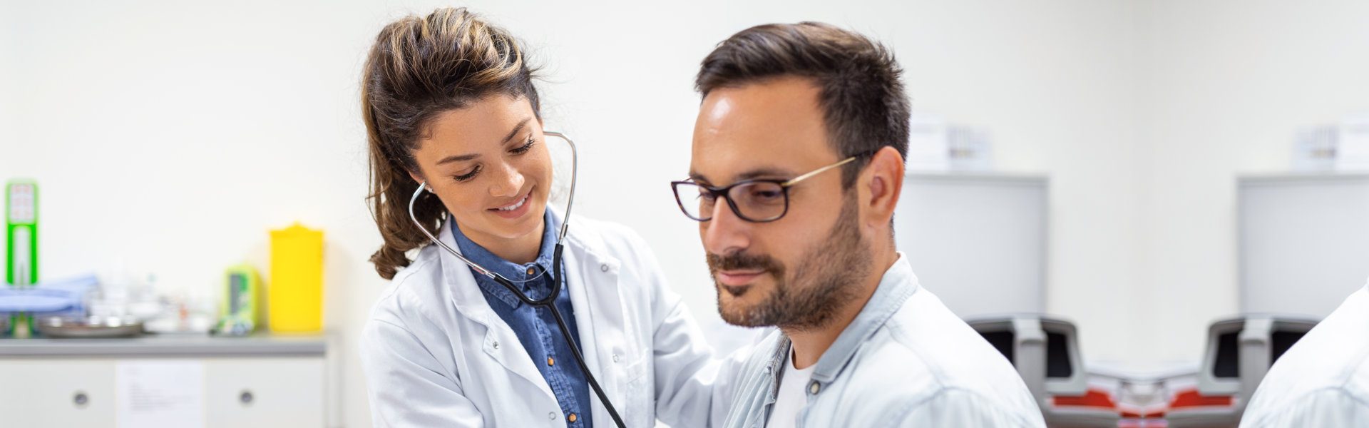 doctor using stethoscope on the patient