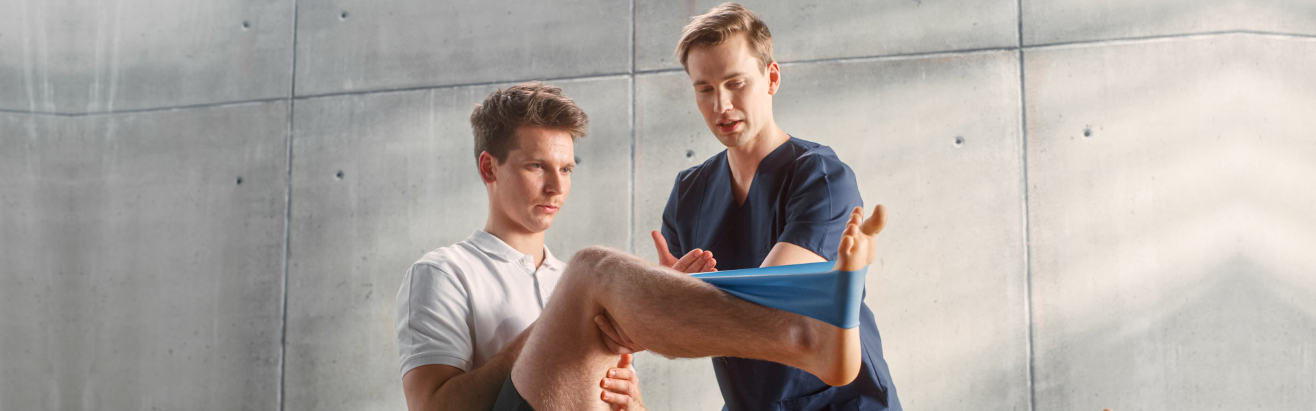 caregiver helping a man stretch his legs