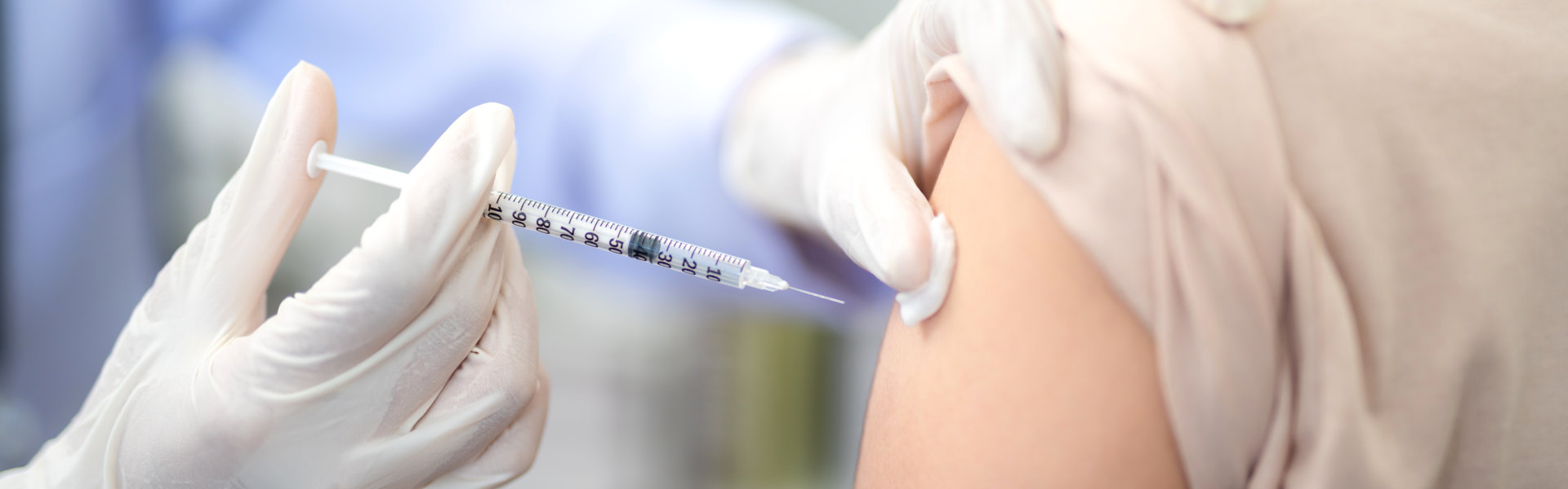 doctor injecting vaccine to patient