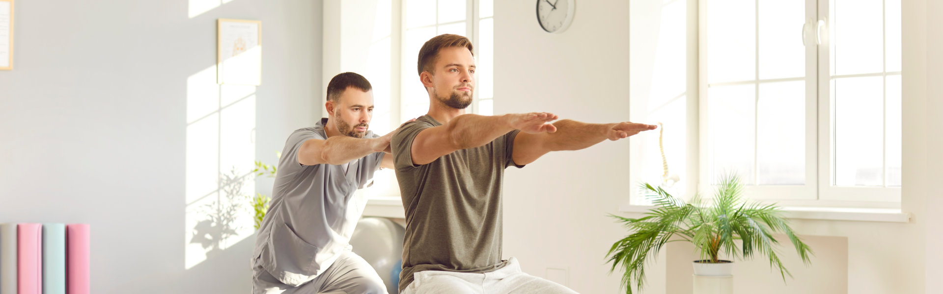 male caregiver helping a man to exercise