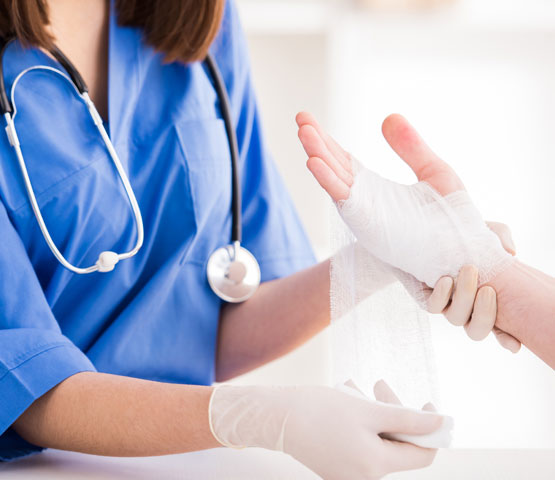 health professional using a bandage to a patient